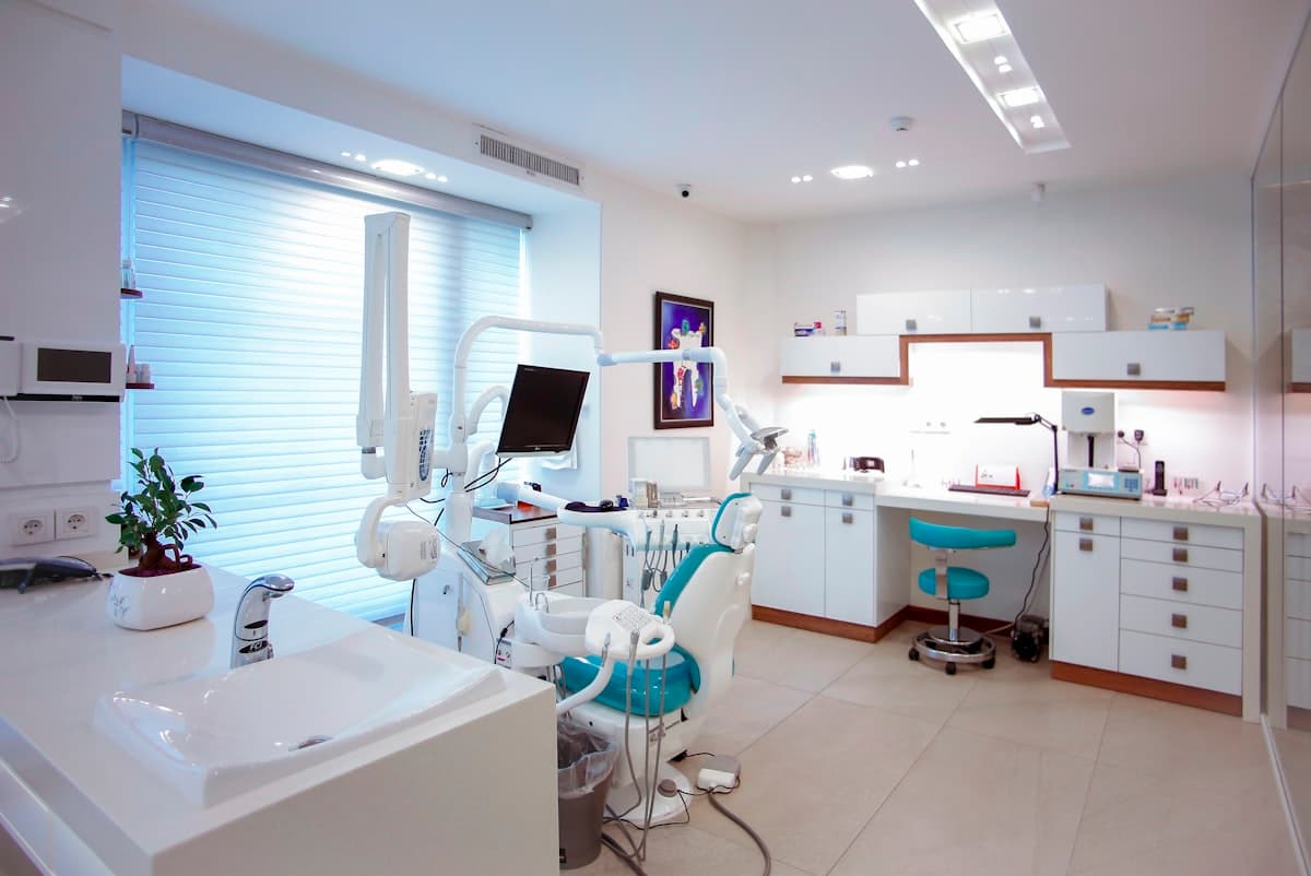 Adelyn Dental clinic exterior — clean white facade with tinted glass storefront